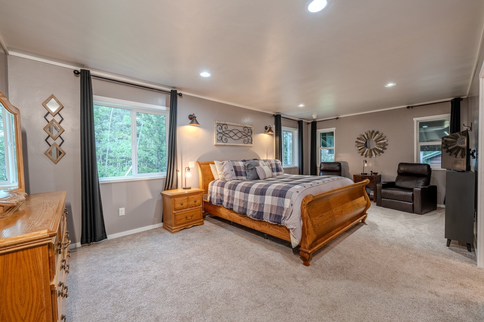 Master bedroom with large bed and seating area