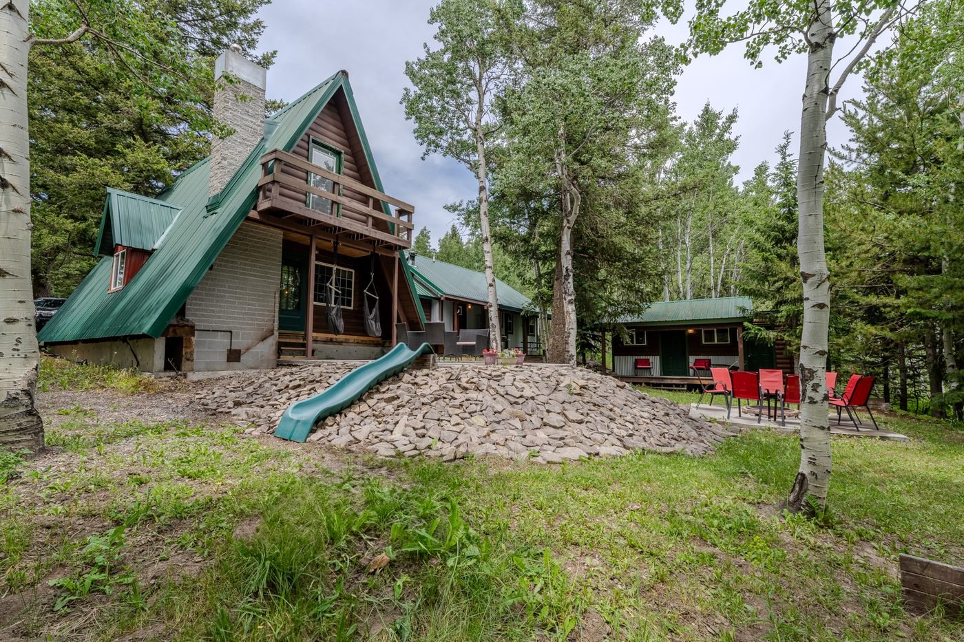 Lazy Moose Lodge backyard with slide and bunkhouse