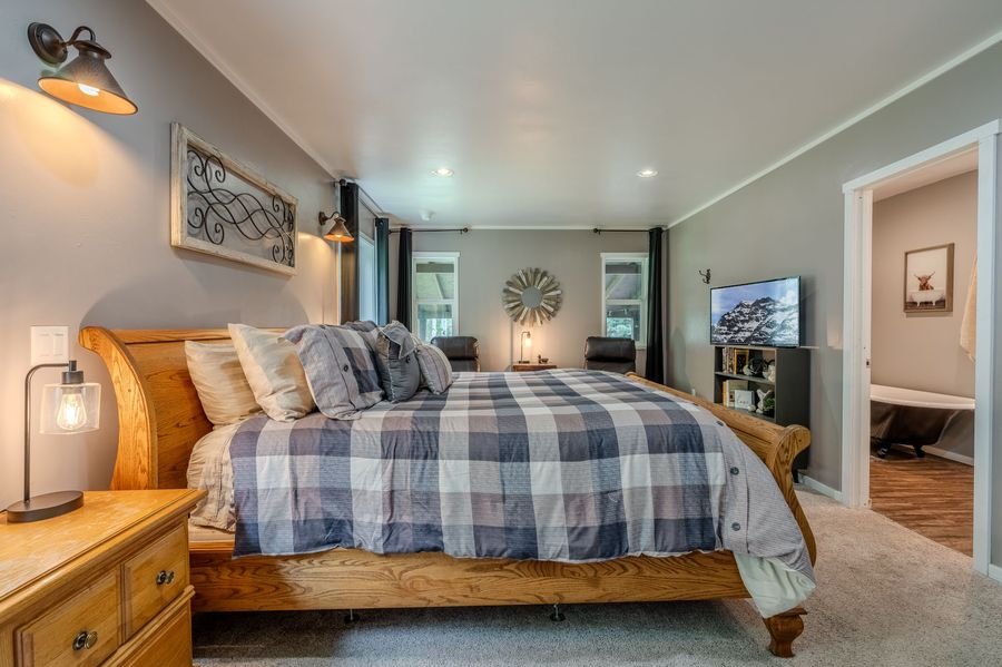 Master bedroom wide angle — sitting area and TV