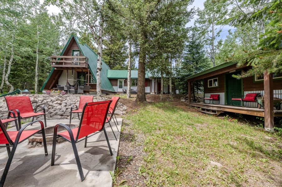 Full property rear view — A-frame, bunkhouse, fire pit