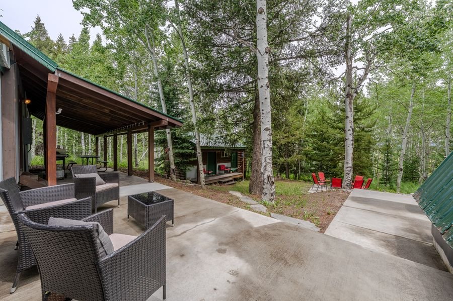 Covered patio and grounds with bunkhouse visible