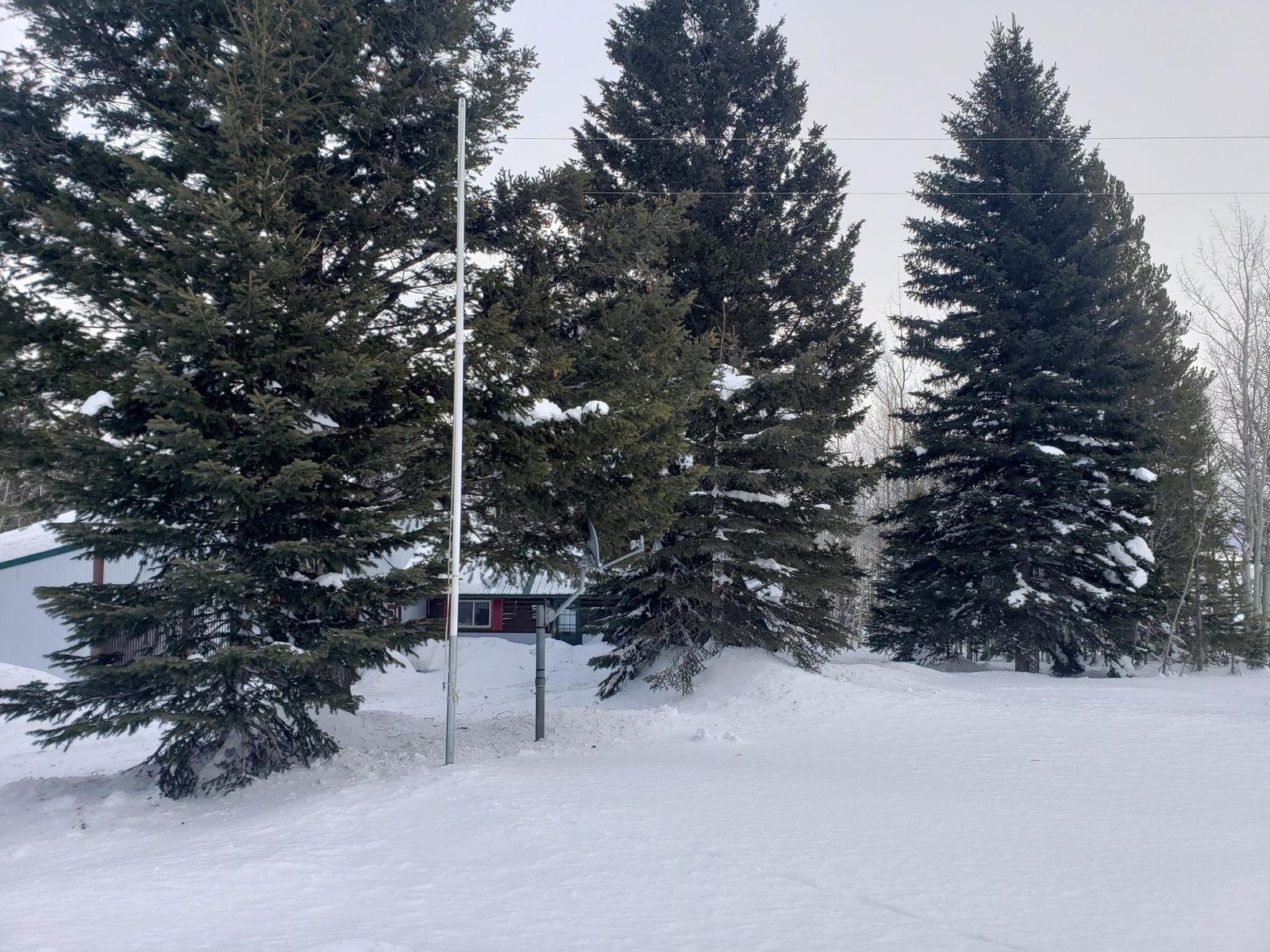 Plowed road and driveway approach to Lazy Moose Lodge, January