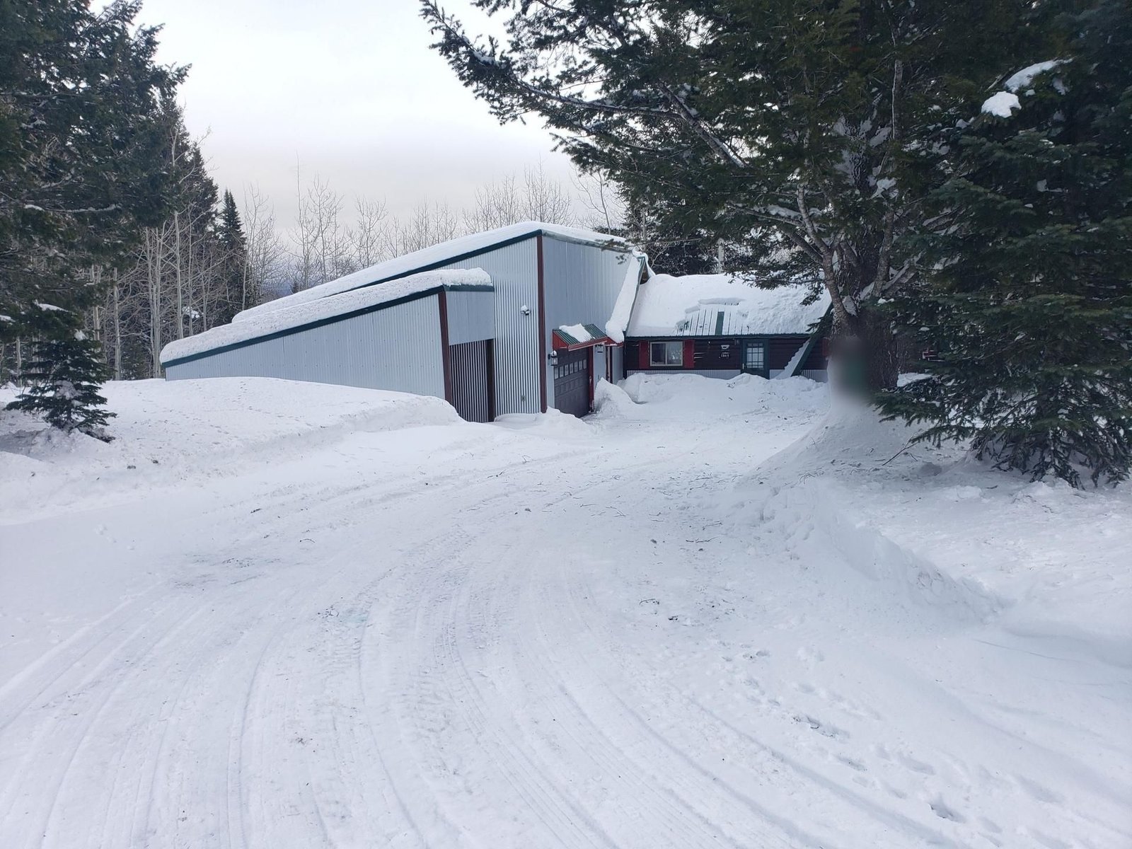 Attached garage and plowed driveway at Lazy Moose Lodge in January snow