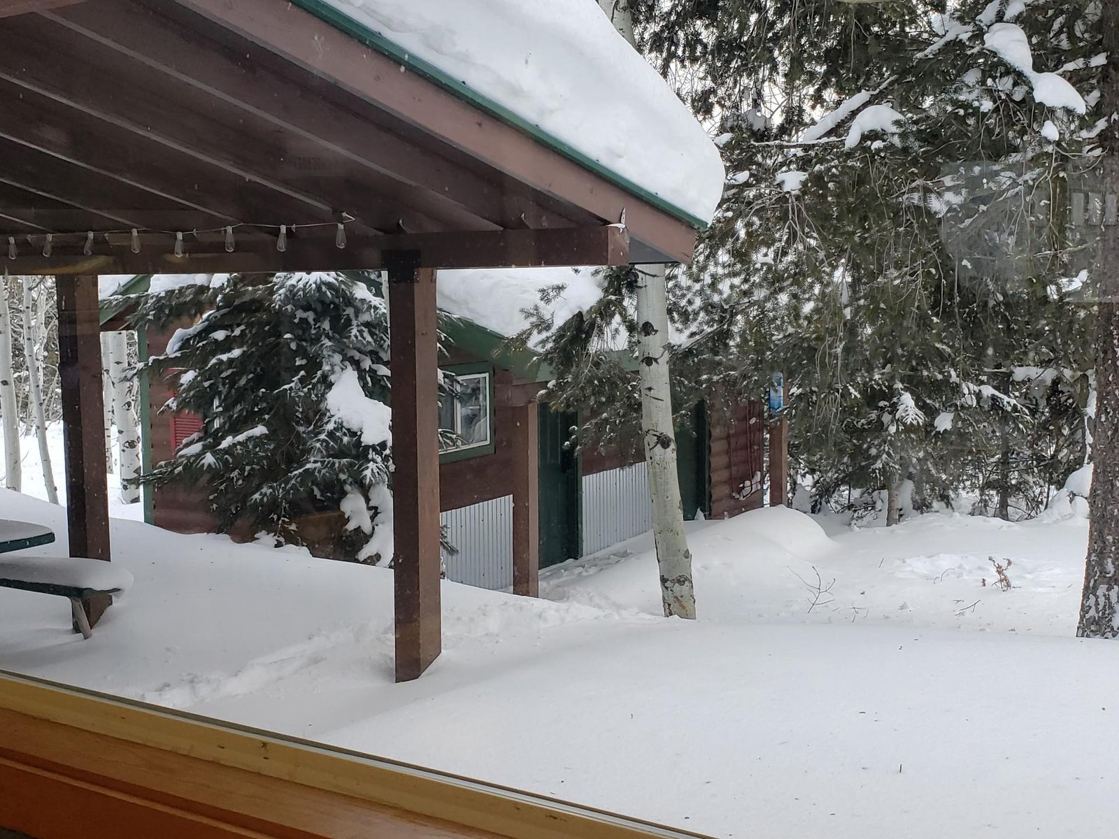 Snow-covered patio and backyard at Lazy Moose Lodge, January